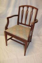 A 19th century elm carver armchair with pierced splat back and upholstered seat on square legs