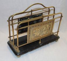 A Victorian brass twin-section magazine rack with panels decorated in relief with flowers on
