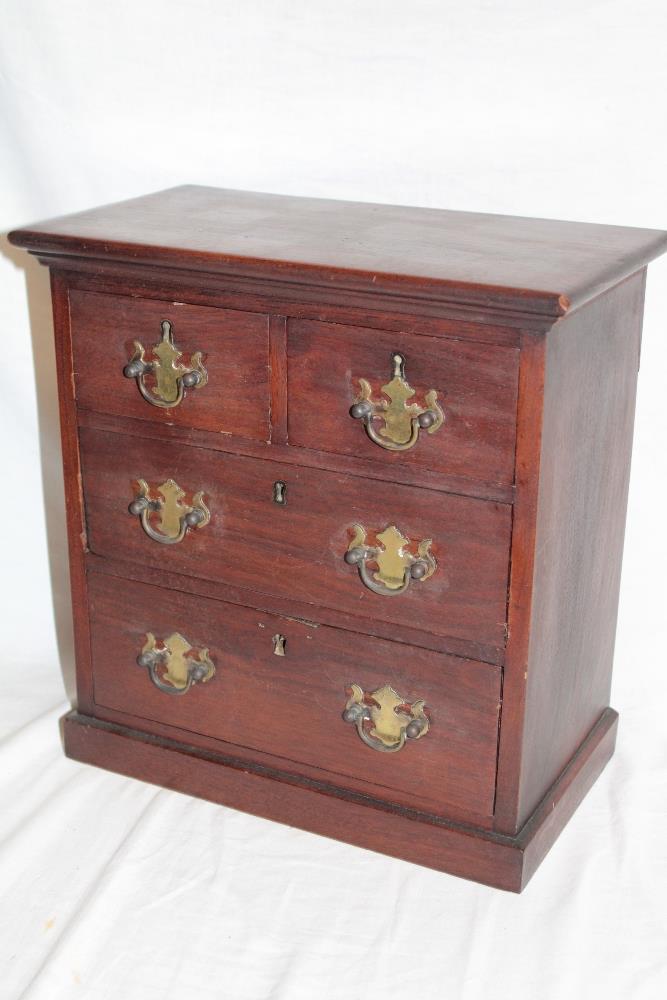 A small mahogany table chest with brass handles,