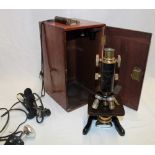 A brass and painted metal monocular (service) microscope by Watson & Sons Limited London in fitted