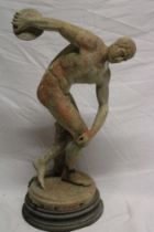 An old weathered marble figure of an athlete with discus, the base marked "INSCOBOLO",