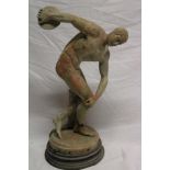 An old weathered marble figure of an athlete with discus, the base marked "INSCOBOLO",