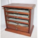 An unusual old brass mounted mahogany table top millinery chest,