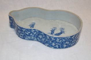 A 19th century Chinese figure-of-eight-shaped oval dish with blue and white floral decoration,