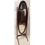 An Edwardian inlaid mahogany bevelled oval cheval mirror on square supports with brass mounts
