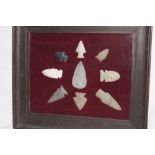 A display of Neolithic spearheads and arrowheads in glazed display frame
