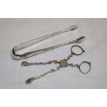 A silver scissor-action sugar tongs with scalloped terminals and a pair of Continental silver sugar