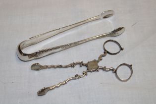 A silver scissor-action sugar tongs with scalloped terminals and a pair of Continental silver sugar