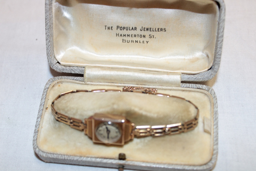 A ladies' 9ct gold wristwatch with circular dial and 9ct gold pierced link strap (14.
