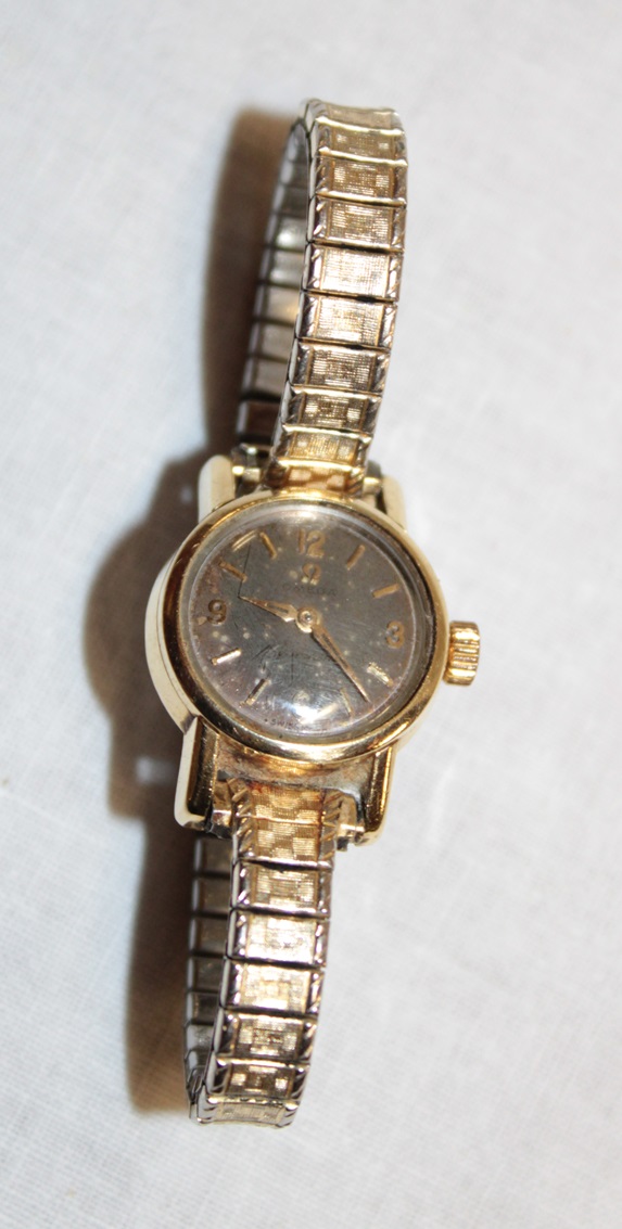 A ladies' gold-plated wristwatch by Omega with elasticated strap