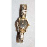 A ladies' gold-plated wristwatch by Omega with elasticated strap