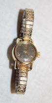 A ladies' gold-plated wristwatch by Omega with elasticated strap