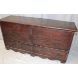 A George III country-style elm mule chest with two base drawers and hinged lid on bracket-style