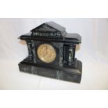 A Victorian mantel clock with gilt circular dial in black slate and marble traditional case