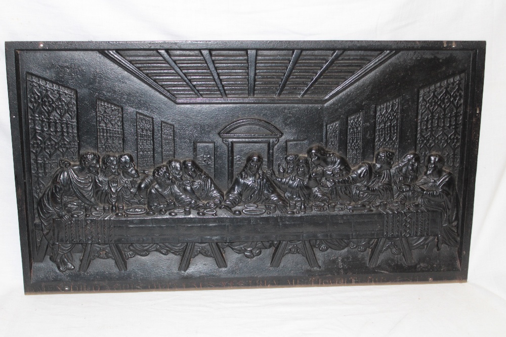 A cast-iron rectangular plaque decorated in relief with scenes from The Last Supper,