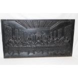 A cast-iron rectangular plaque decorated in relief with scenes from The Last Supper,