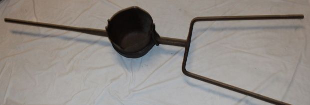 A large 19th century Cornish mining smelting iron pot with double pouring lips and iron frame,