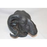 An old cast metal wall plaque in the form of a ram's head with horns,