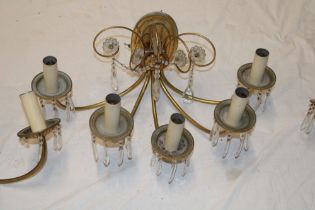 Five matching brass wall lights comprising a five branch wall light with glass lozenge droplet