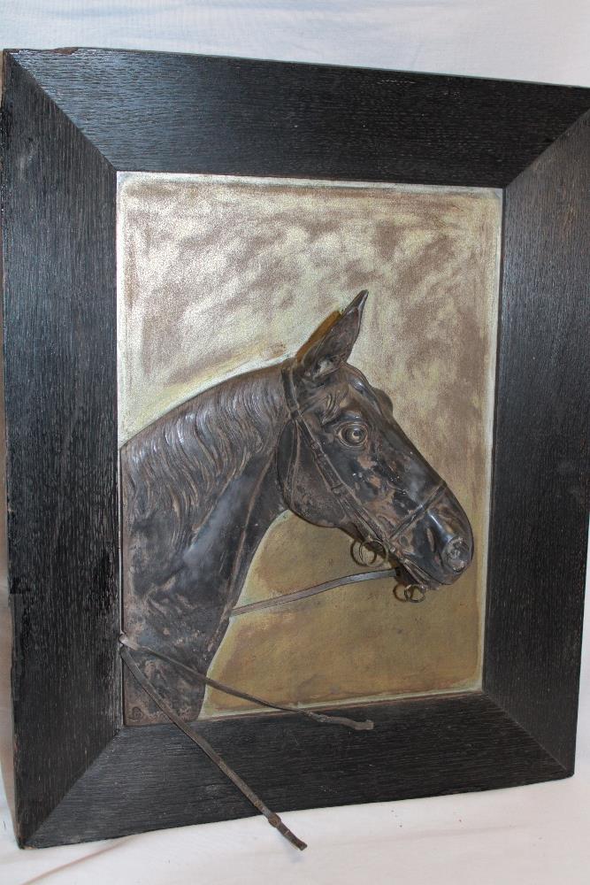 A silver-plated bust study of a race horse on silver-plated panel within oak frame,