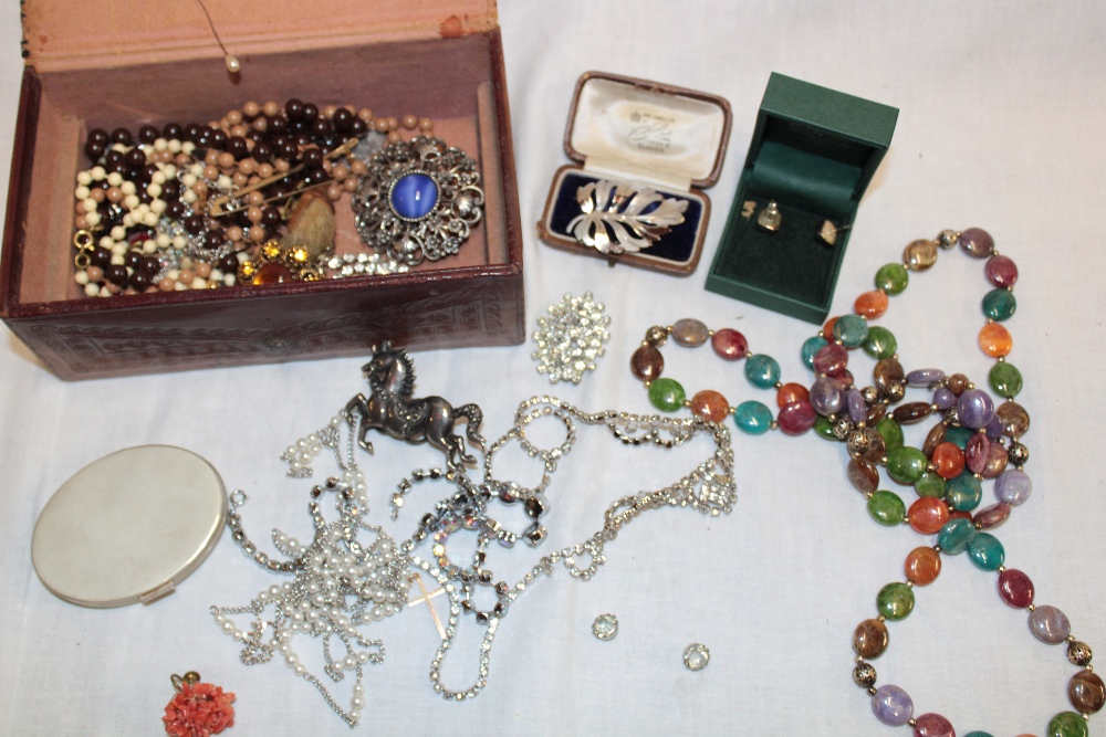 A jewellery box containing a quantity of various costume jewellery