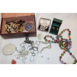 A jewellery box containing a quantity of various costume jewellery