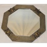 A bevelled octagonal wall mirror in pewter and oxidised metal frame,