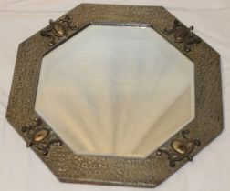 A bevelled octagonal wall mirror in pewter and oxidised metal frame,