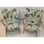 A pair of 1960's Ercol pale elm open arm easy chairs,