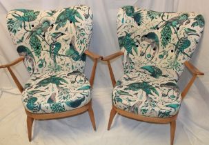 A pair of 1960's Ercol pale elm open arm easy chairs,