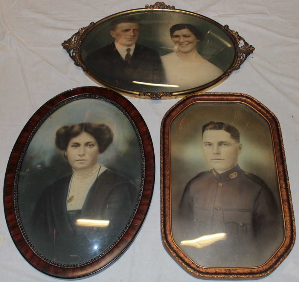 Three ornamental photo frames with convex glass including ornate brass oval photo frame,