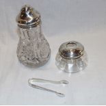 A cut-glass suger sifter with silver mounted top,