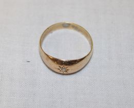 An 18ct gold gypsy-style ring inset with a diamond (2.