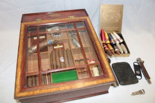 An inlaid mahogany sloping front cigar cabinet with fitted interior enclosed by a glazed hinged