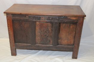 A 17th century-style oak rectangular coffer with triple panelled front and hinged lid on block feet,