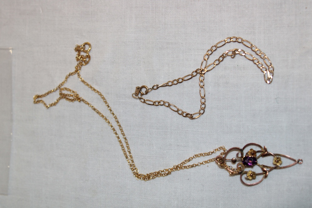 A 9ct gold chain link necklace supporting a gold plated Art Nouveau-style pendant set amethyst and