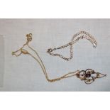 A 9ct gold chain link necklace supporting a gold plated Art Nouveau-style pendant set amethyst and