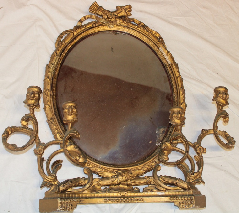 A George III oval wall mirror/over mantel mirror in ornate gilt frame with two attached pairs of