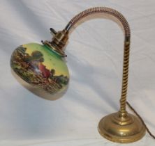 A 1920's/30's brass adjustable desk lamp with landscape scene opaque glass circular shade