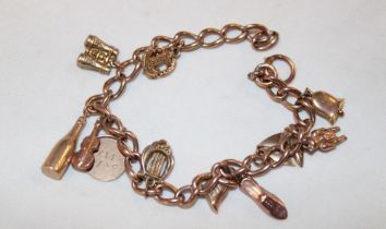 A 9ct gold charm bracelet supporting various 9ct gold and other charms (20.