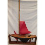 An old wooden model pond yacht with weighted keel and nylon sails,