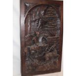 A Continental carved wood plaque depicting a deer hunting scene,