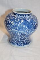 A 19th century Chinese tapered vase with blue and white floral decoration, signed,