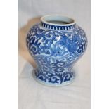 A 19th century Chinese tapered vase with blue and white floral decoration, signed,