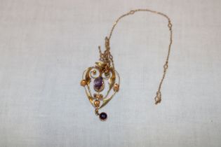 An Art Nouveau 9ct gold pendant set amethyst together with fine link chain (3.