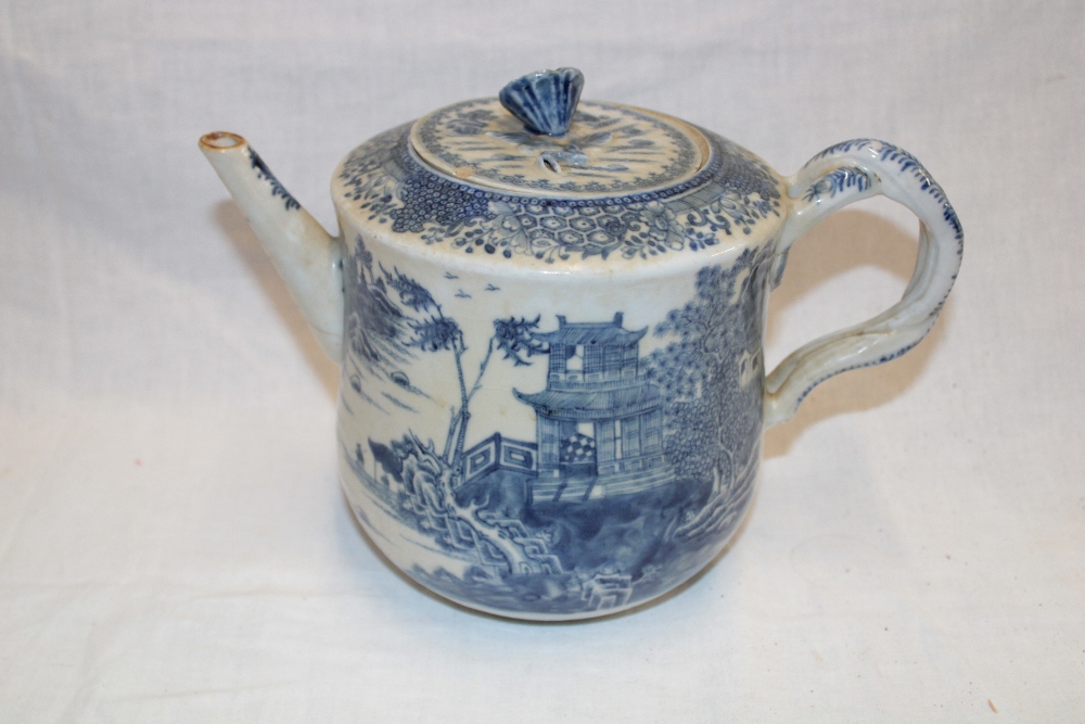 An 18th century Chinese circular tea pot with blue and white landscape and floral decoration and