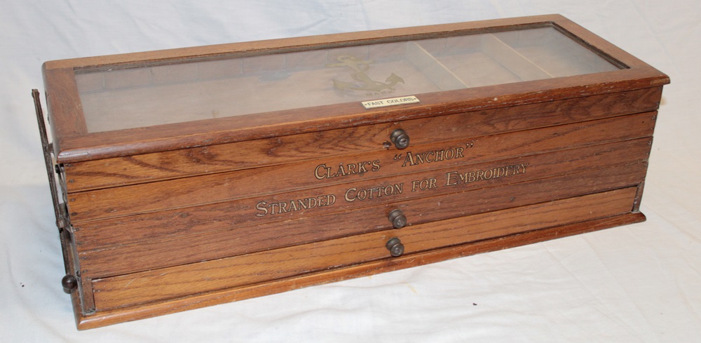 A Clark's "Anchor" cotton-reel cabinet with cantilever-action drawers for "Fast Colors",