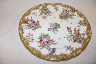 A Sampson china circular plate with painted floral decoration within gilt borders,