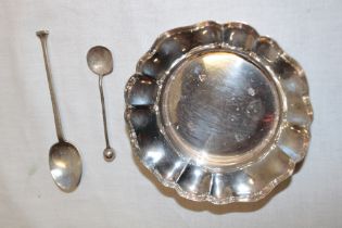 A small silver circular ornamental bowl with foliate edge,