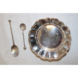 A small silver circular ornamental bowl with foliate edge,